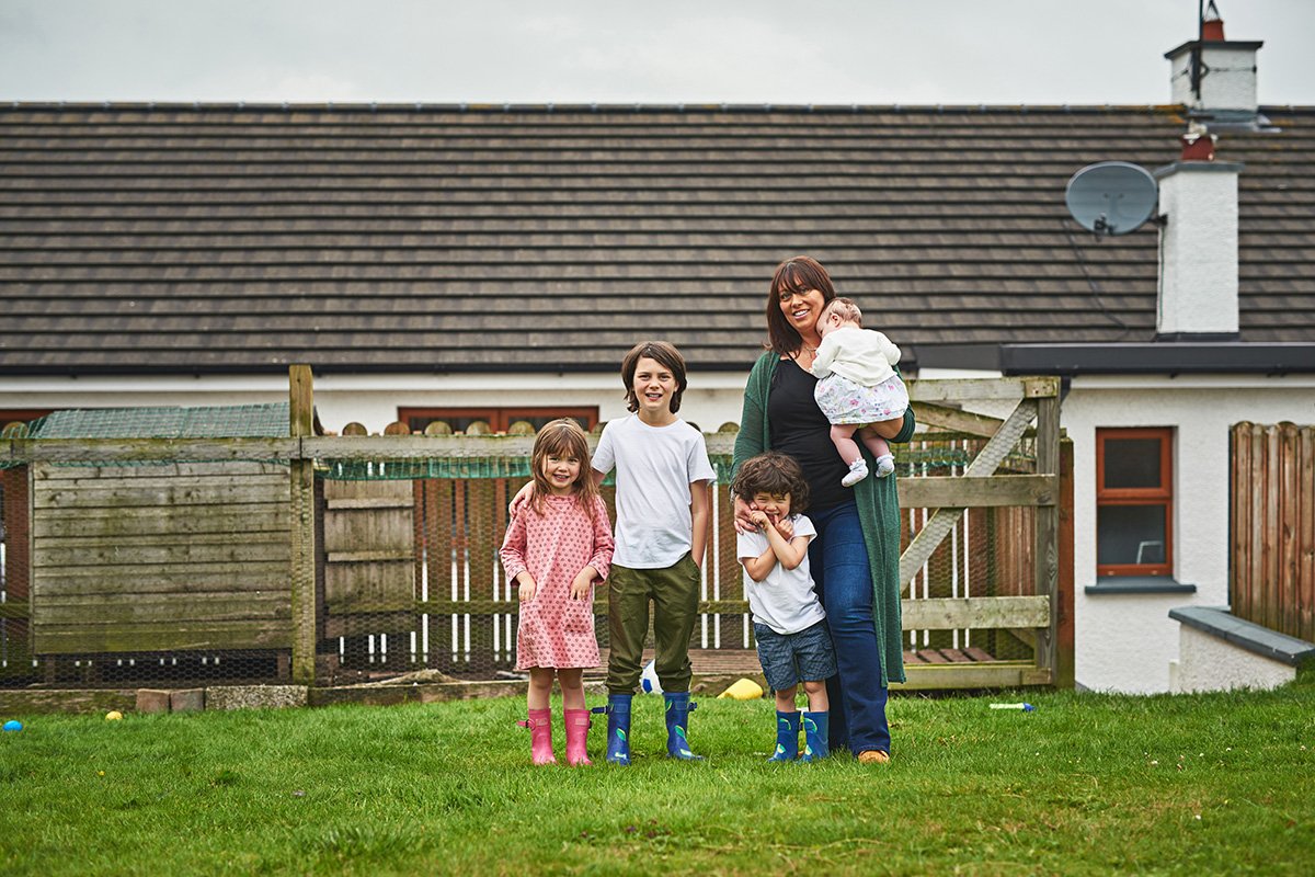 family in front of house