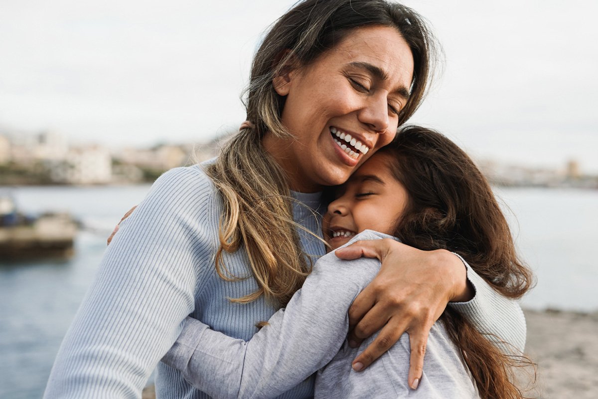 woman and daughter hugging